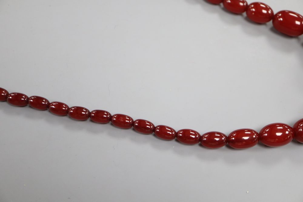 A single strand graduated cherry amber bead necklace, 75cm, gross 66 grams.